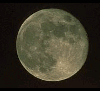 Witches flying across full moon